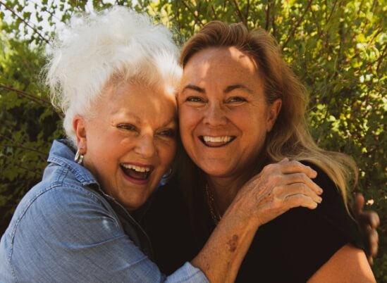 Older women hugging and smiling